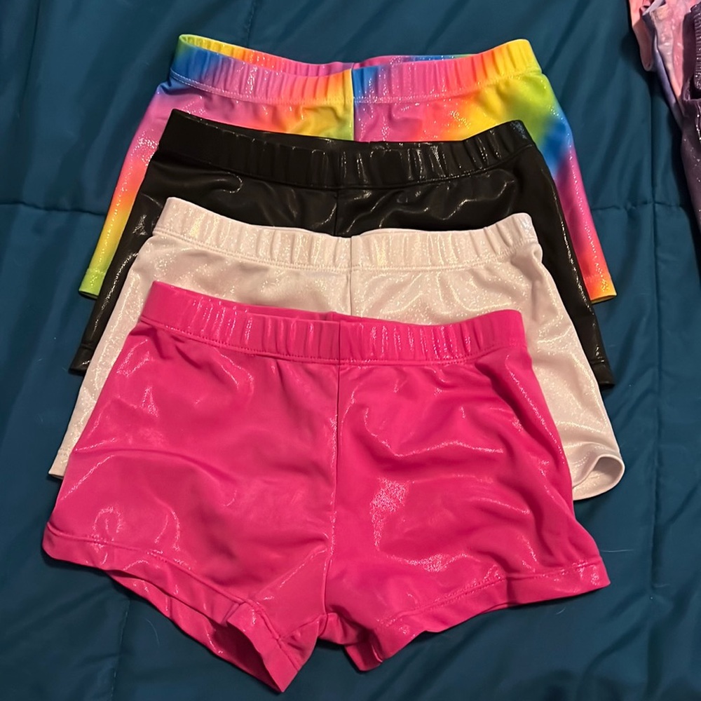 Lot of girls size 7 gymnastics leotards and shorts.